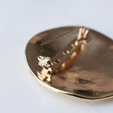 flat metal brooch