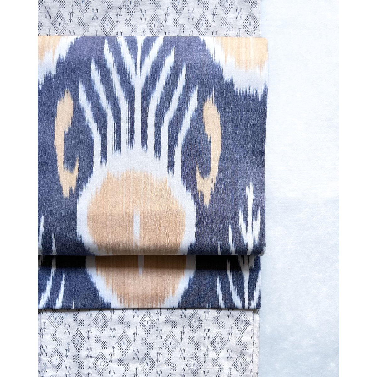 ウズベキスタン絣 木綿九寸名古屋帯 紅掛花色×花葉色（仕立て上り