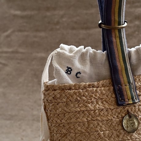 Raffia basket one handle bag with antique linen