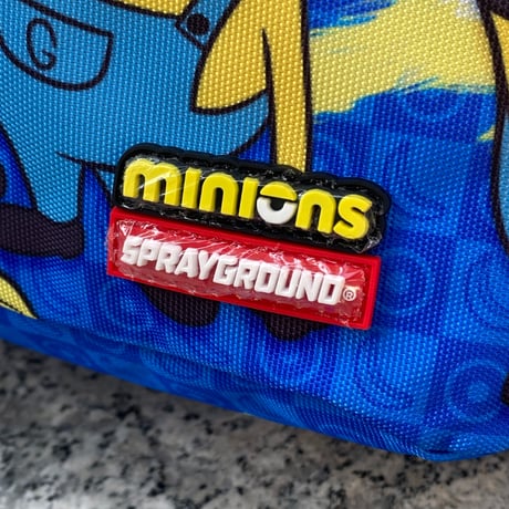 米国仕様 SPRAYGROUND ミニオンズ Minions マッドネス ペイント シャークマウス バックパック (BKPK7)