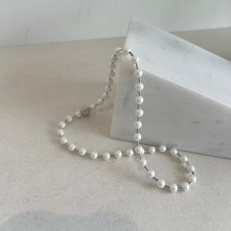 between petit pearls necklace