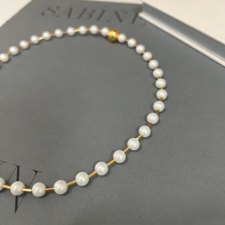 between petit pearls necklace