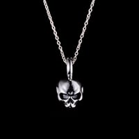 Half skull charm