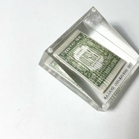 USED 70'S "THE SHRINKING DOLLAR" RIPPLED BILL PAPERWEIGHT