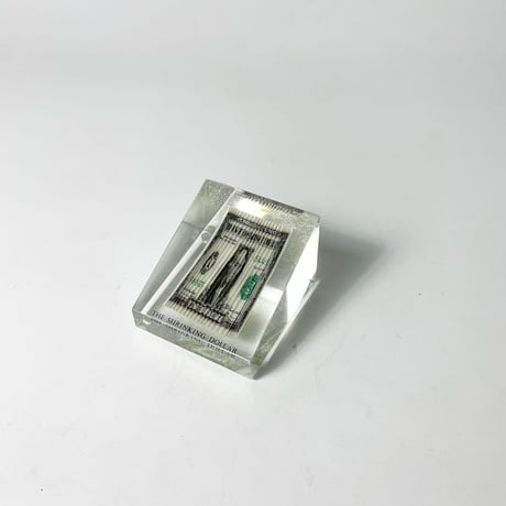 USED 70'S "THE SHRINKING DOLLAR" RIPPLED BILL PAPERWEIGHT