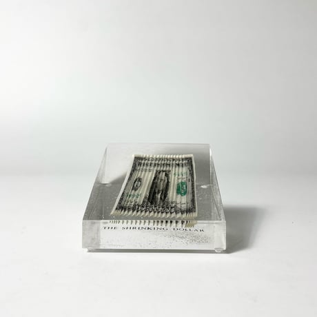 USED 70'S "THE SHRINKING DOLLAR" RIPPLED BILL PAPERWEIGHT