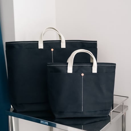 This is a(n) Ex. Leather Handle Base Tote S