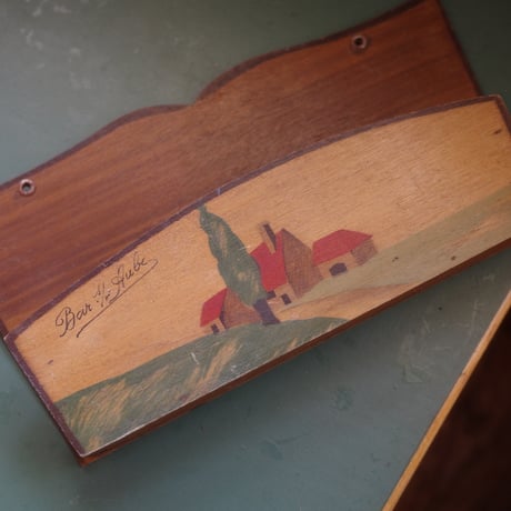 Letter rack of a red-roofed house on a hill