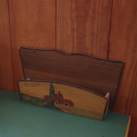 Letter rack of a red-roofed house on a hill