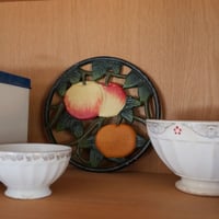 Iron trivet with fruit motif