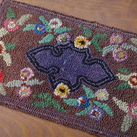 Small floral hooked rug
