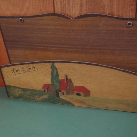 Letter rack of a red-roofed house on a hill