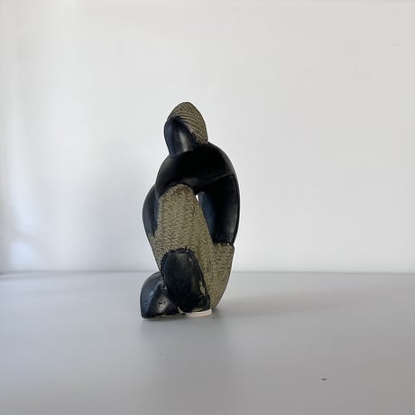 black stone object person sitting 80-90s