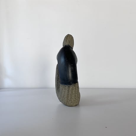 black stone object person sitting 80-90s