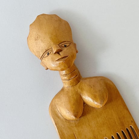 African effigy wooden comb