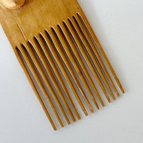African effigy wooden comb