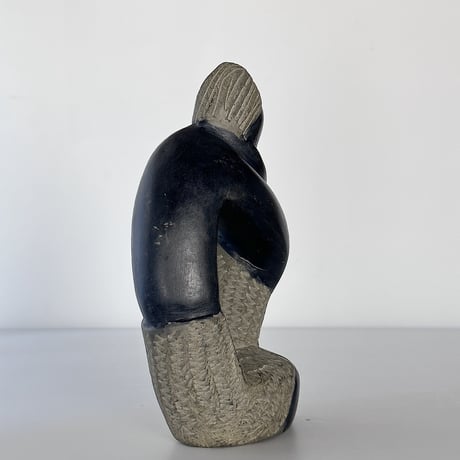 black stone object person sitting 80-90s