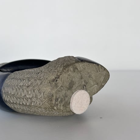 black stone object person sitting 80-90s