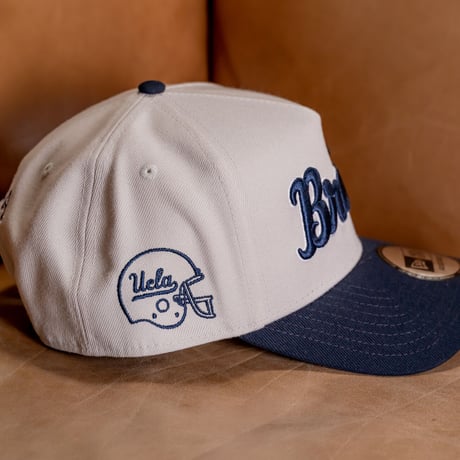 NEW ERA・ニューエラ　 9FORTY A-Frame UCLA Bruins ブルーインズ　ストーン × ネイビー スノーホワイト ネイビーバイザー