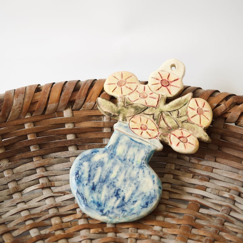 青い花瓶がお気に入りの黄色いたんぽぽの壁掛け | Boris Pottery