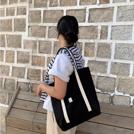 white on black tote bag