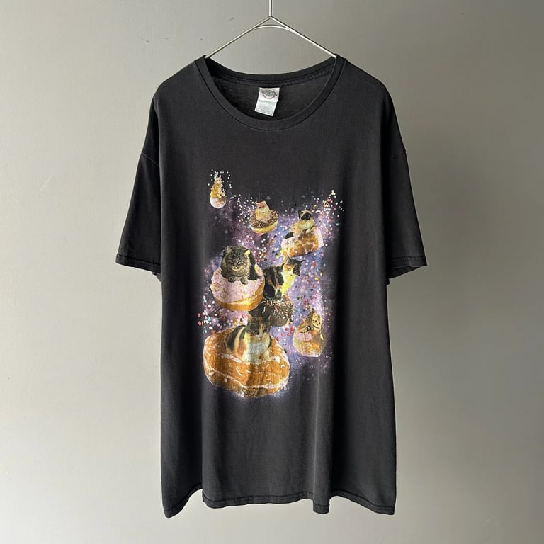 cat riding a donut in the galaxy print tee