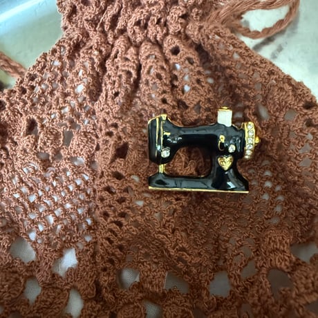 Sewing machine brooch