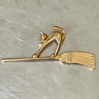 Cat and broom brooch