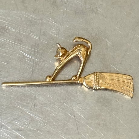 Cat and broom brooch