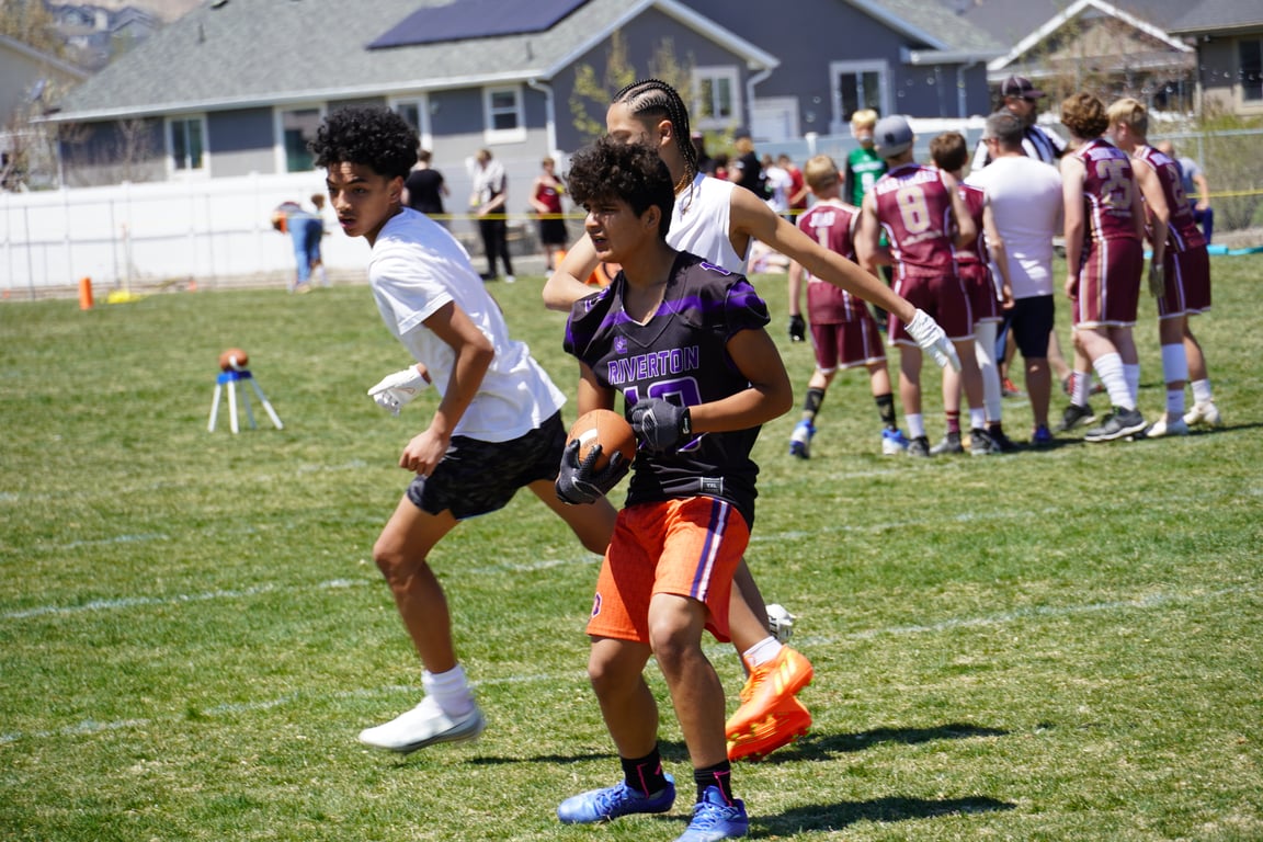 Youth football player catching a pass during Air Raid 7's tournament