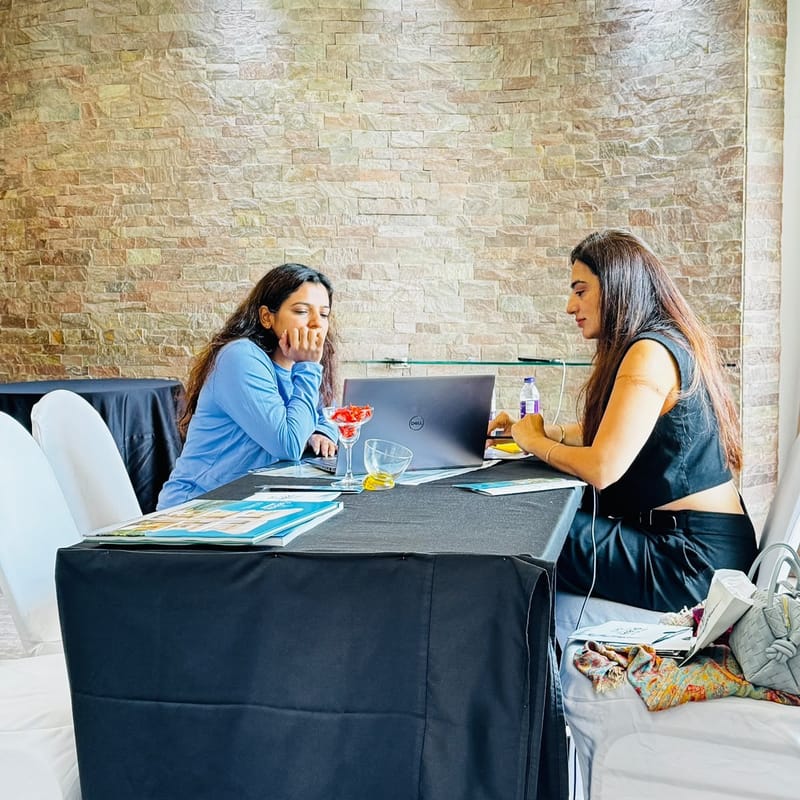 An attendee discussing project brochures with a Cube Realty advisor