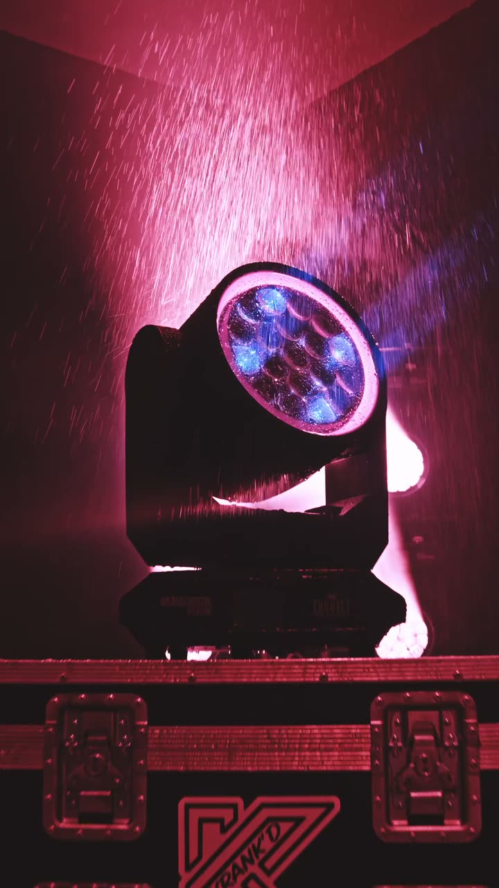 Chauvet Maverick Storm 2 IP65 moving head under simulated rain, pink and amber light