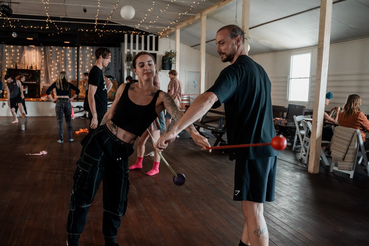 Flow-arts performer in a workshop-room setting