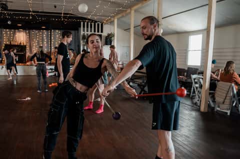 Flow-arts performer in a workshop-room setting