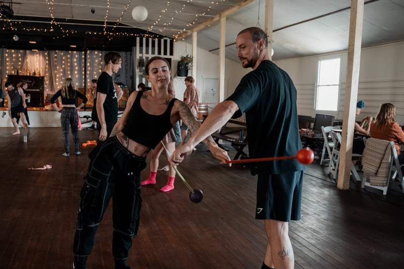 Flow-arts performer in a workshop-room setting