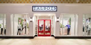 Talbots storefront in a mall with red double doors, glass display windows and mannequins in women's clothing