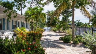 Marco Island Lakeside Inn exteior garden walkway lake pool 16x9 1200