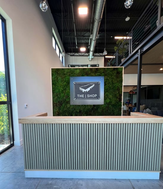 The shop moss wall sign