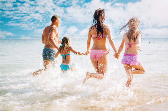 Family kids playing in gulf naples vacation