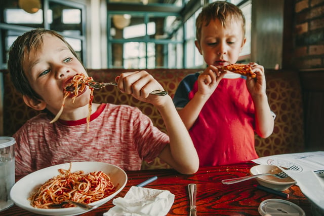 Kids eating pasta