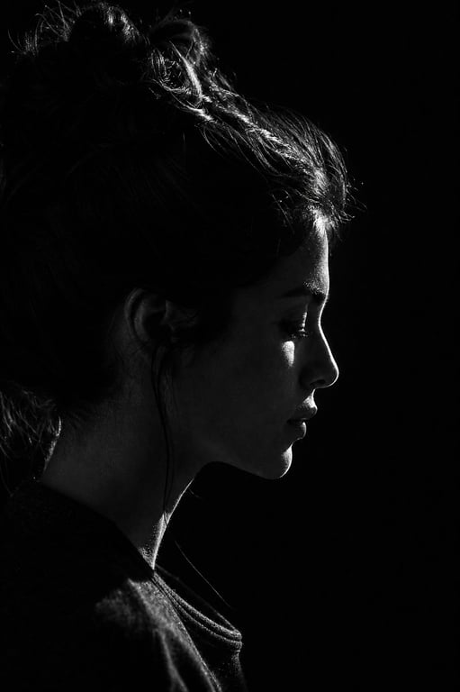 Cinematic Pensive Side Profile Subject Monochrome Chiaroscuro Closeup generated image