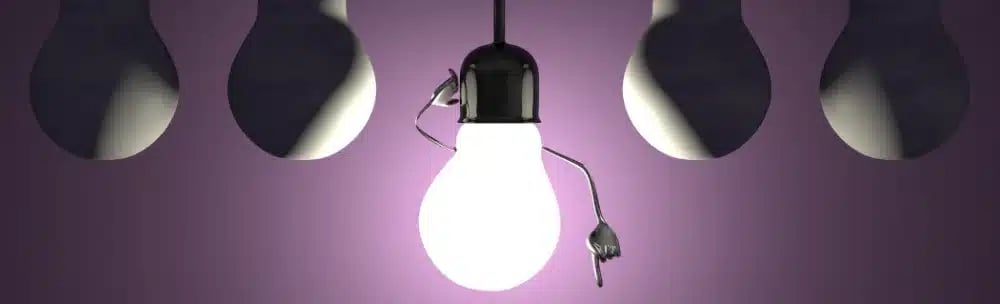 A bright light bulb standing out among dim bulbs, representing the importance of not overlooking customer insights in real