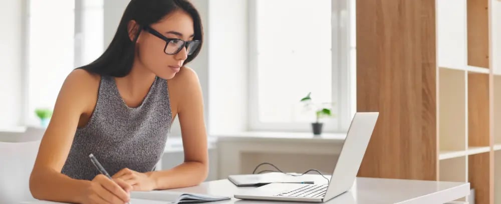 Real Estate Professional Reflecting on Mastering ChatGPT Techniques with Laptop