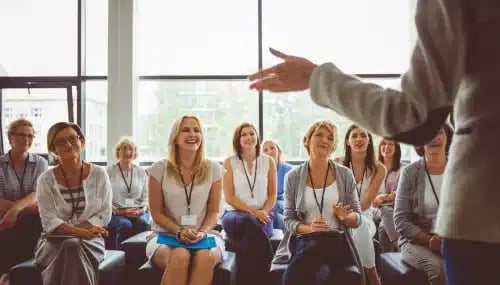Group of real estate agents attending a training program, highlighting the importance of asking about training in brokerage