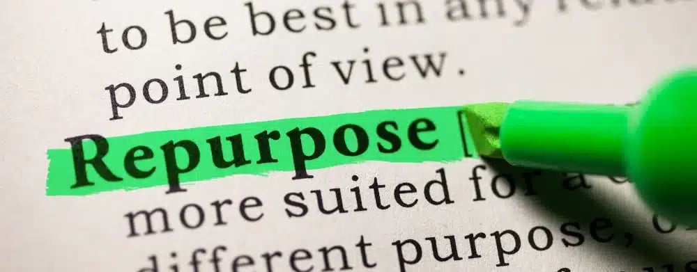 Highlighted word 'Repurpose' with a marker on text, denoting strategic content repurposing in real estate YouTube marketing