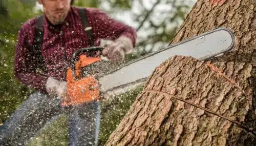 Real Estate Simplification - Man Using Chainsaw Symbolizing the Breakdown of Complex Tasks with ChatGPT