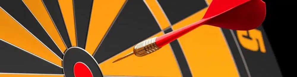 Red dart hitting the bullseye on a dartboard, representing the importance of retargeting in real estate agent marketing