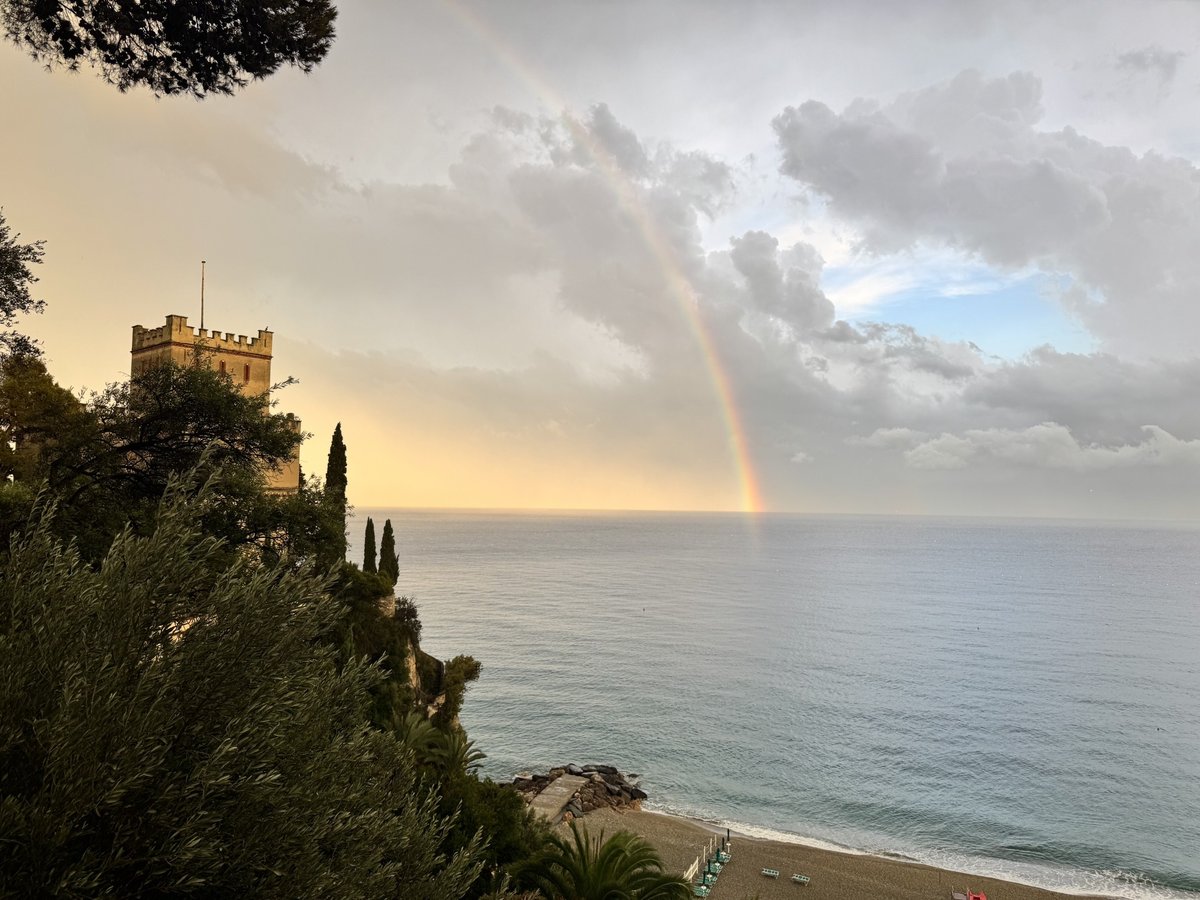 Uitzicht op zee met regenboog, gezien vanaf de kust tijdens vakantie
