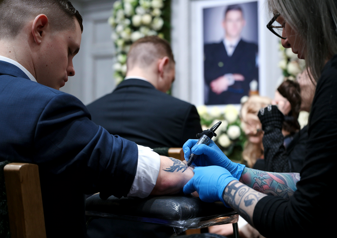 Tattoo artist working on a client during a private event