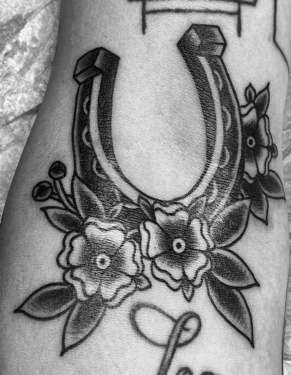 Traditional Horseshoe Tattoo with Flowers